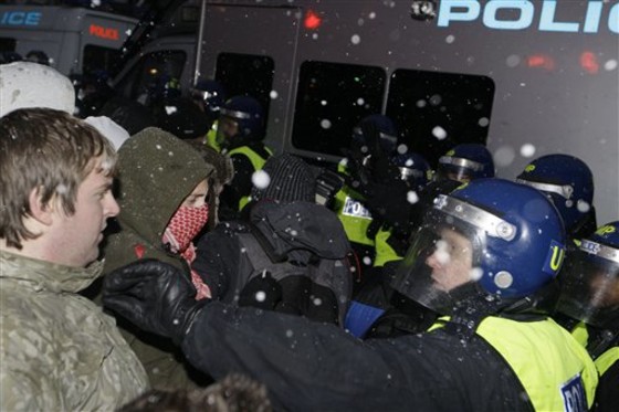 British police officers clash with protesters as hundreds of students demonstrate against a rise in tuition fees at Trafalgar Square, London, on Tuesday.